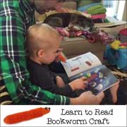 Logan uses his bookworm pointer craft to read books with his dad  - Find out how to make this craft on www.daniellesplace.com